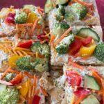 crescent roll veggie pizza with broccoli, peppers, and cucumber