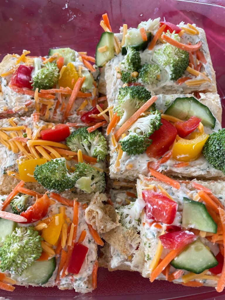 crescent roll veggie pizza with broccoli, peppers, and cucumber